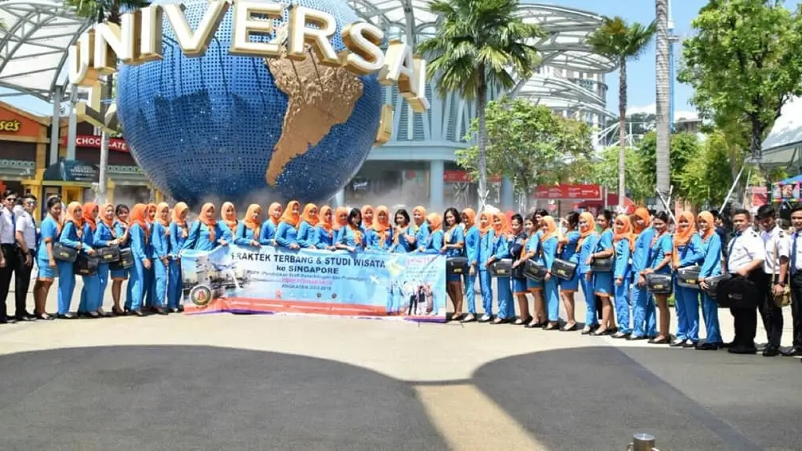 Sekolah Aviasi terakreditasi. Pelajar pramugari pilot studi wisata di Universal Studios Singapura.